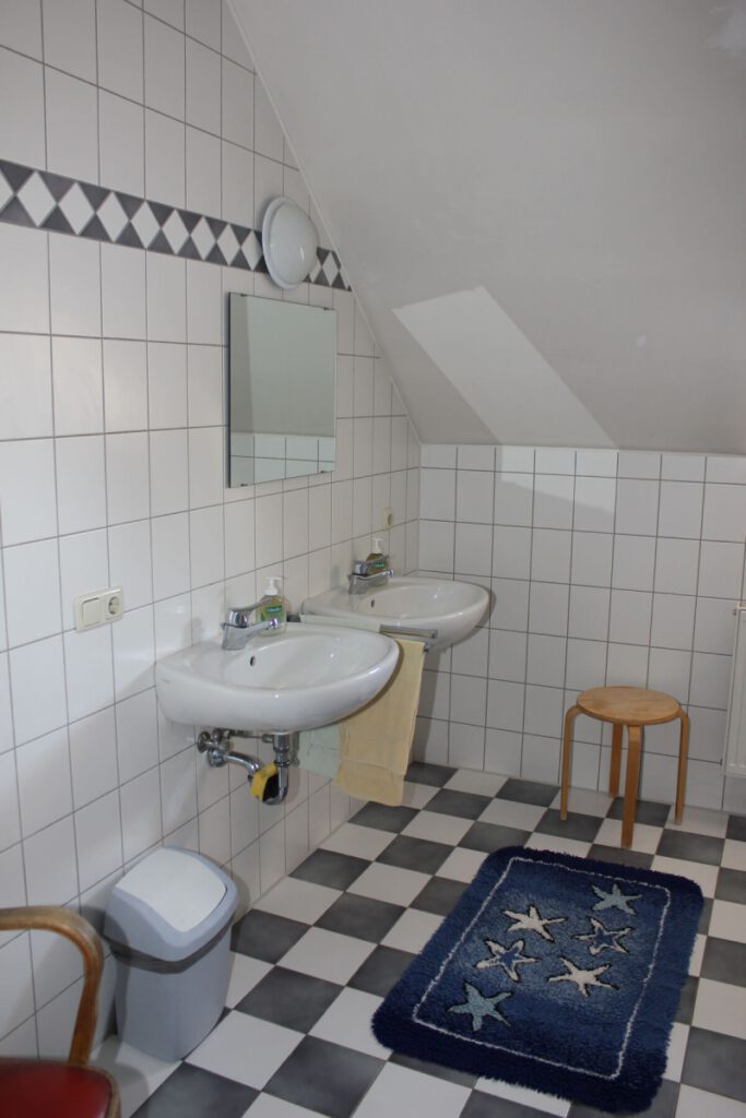 Ein Badezimmer mit zwei Waschbenken und einem Spiegel